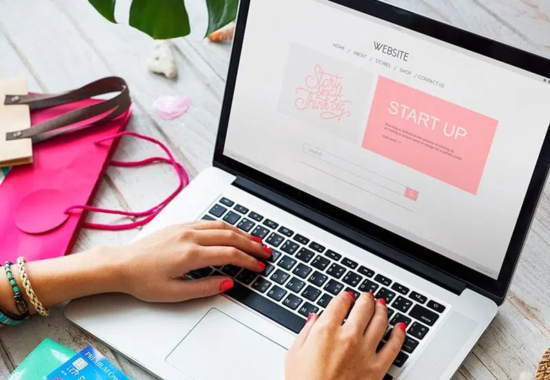 You-have-a-new-websites-now Person typing on laptop with website