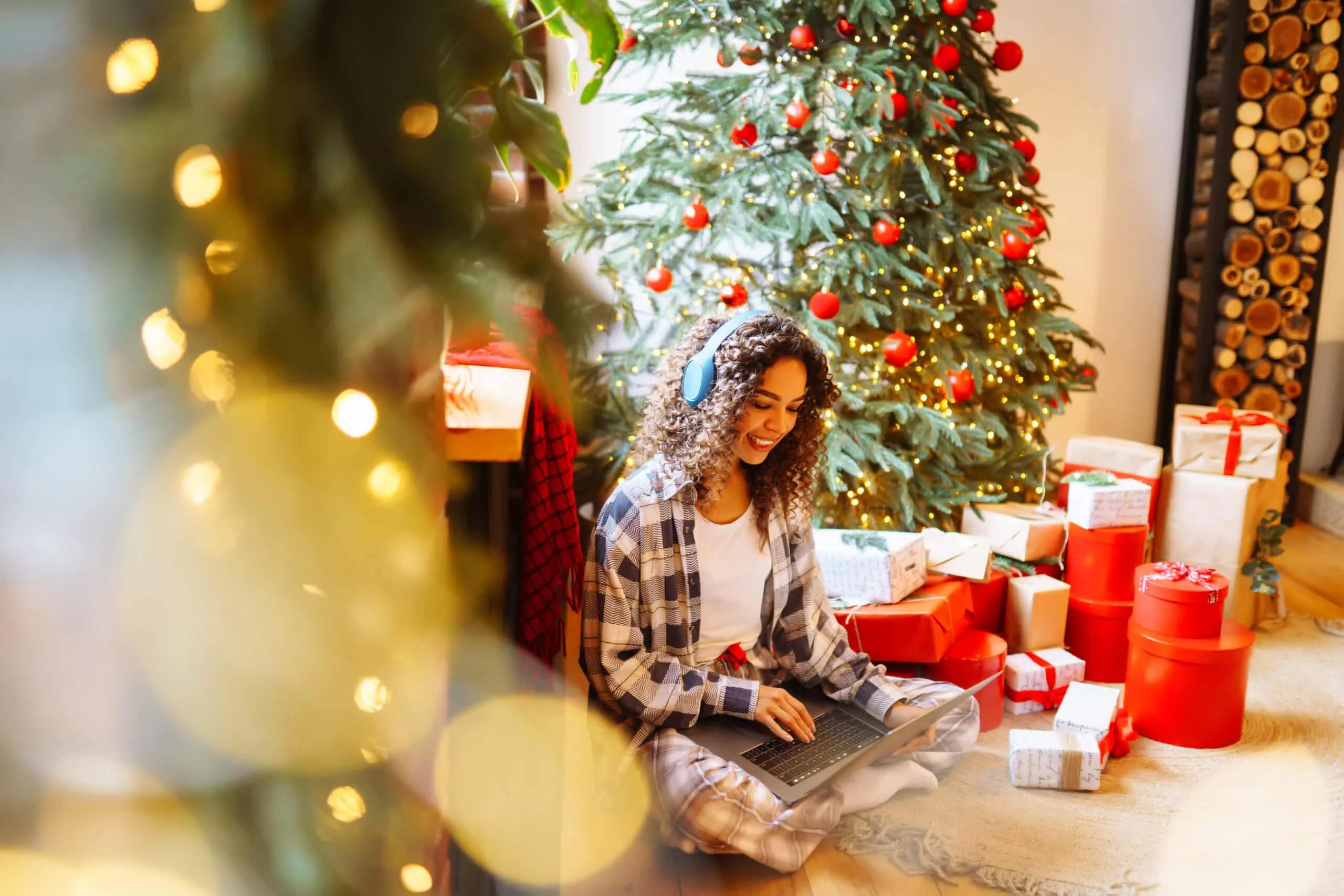 christmas-online-holiday-young-woman-uses-laptop-2022-10-28-21-51-44-utc-scaled Woman using laptop near Christmas tree