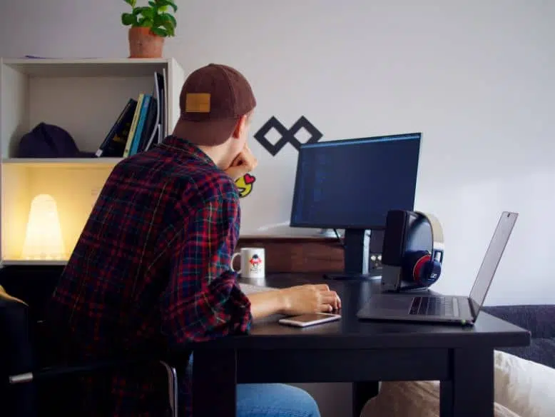 vpn-importance-fo-web-dev Person working at a desk with technology.
